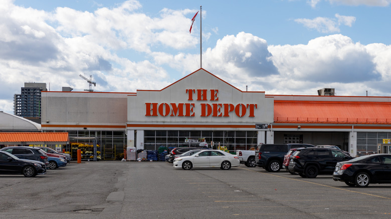 The facade of a Home Depot store, a large parking lot in front