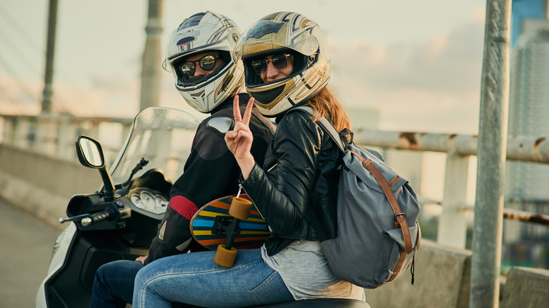 Motorcycle riders waving to other riders