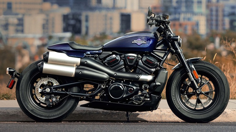 A dark blue 2025 Sportster S parked along a city street.