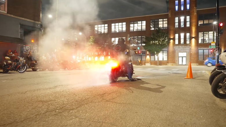 Biker burning rubber during Motoblot as others look on