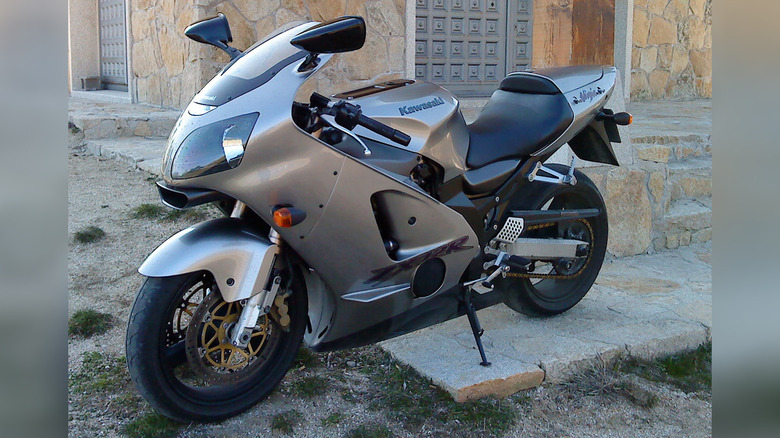 Kawasaki Ninja ZX112R parked on a street.