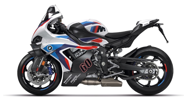 A 2024 BMW M1000R naked superbike in white M Motorsport livery with the number 60 is shown in an official press photo against a white background.