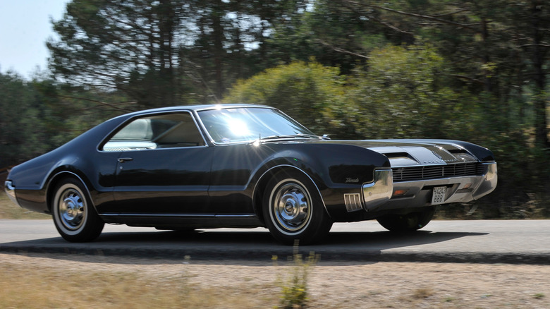 1966 Oldsmobile Toronado driving along road, front-right 3/4 view
