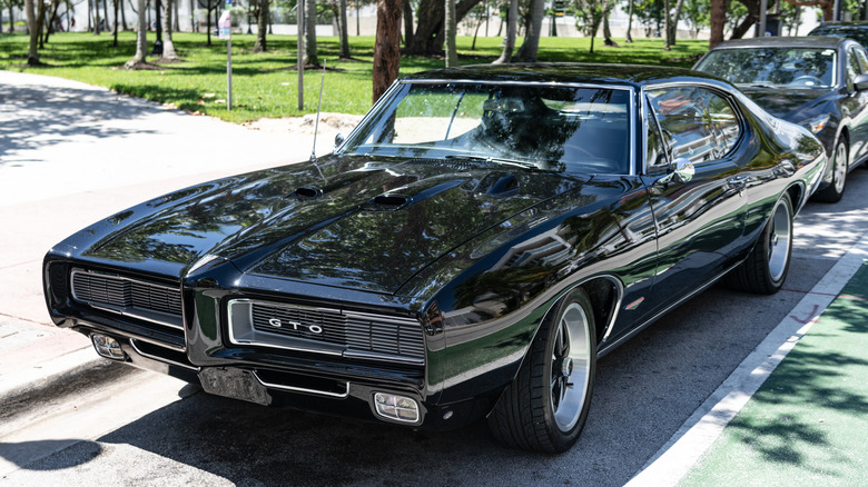 1968 Pontiac GTO parked along roadside, front-left 3/4 view