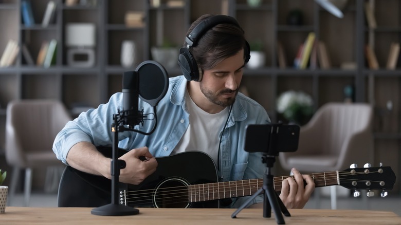 Man recording music with smartphone
