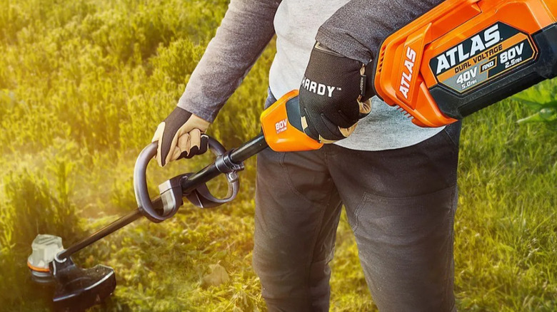 Person using Atlas string trimmer