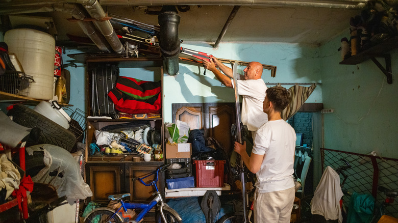 two men in messy garage