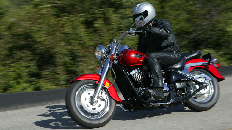 rider driving a red kawasaki