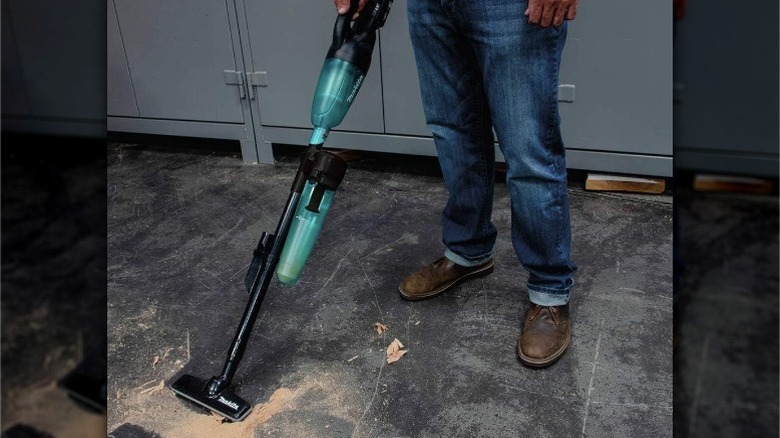 Person using Cyclonic Vacuum Attachment on shop vac