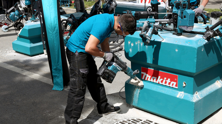 Person testing Makita tools on display