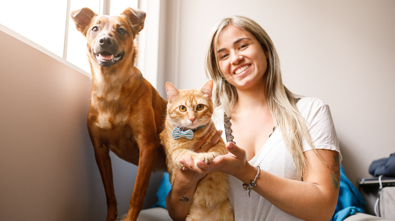 Pet owner with dog and cat 