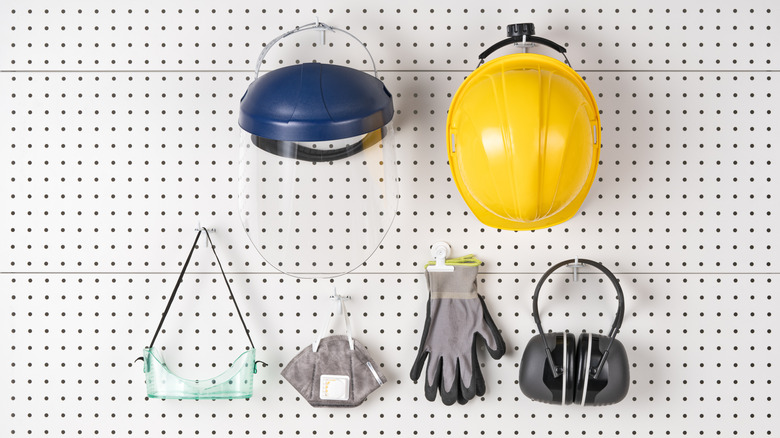 jobsite safety gear hanging on peg wall