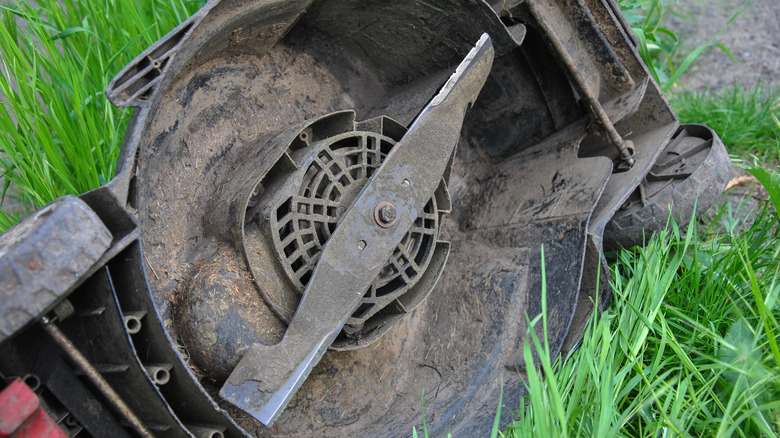 lawn mower on its side showing blade