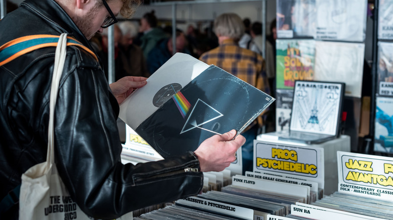 Man browsing a table of used records at a record fair