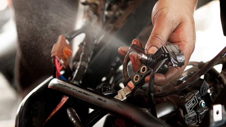 Fuel injector spraying motorcycle