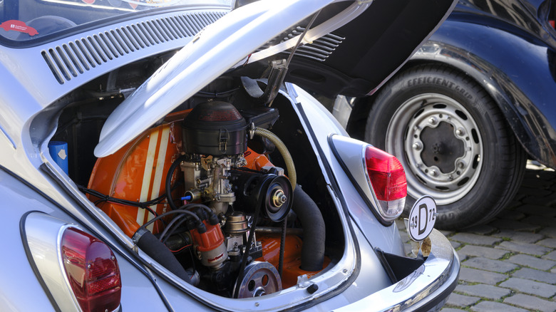 A close-up of a vintage VW Beetle engine bay.