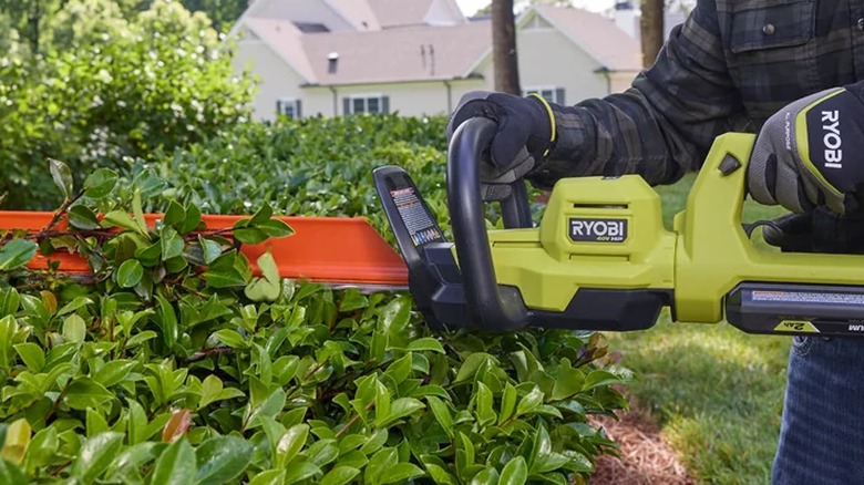A person using a Ryobi 40V HP Brushless 26