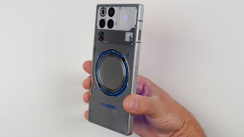 Hand holding the RedMagic 11 Pro in front of a white background