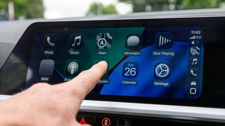 A person using Apple CarPlay on iOS 26