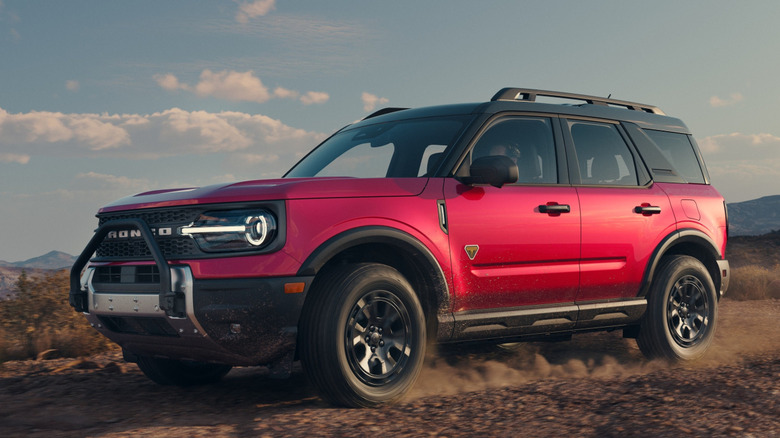 Front 3/4 view of Ford Bronco Sport driving off-road on a dirt trail