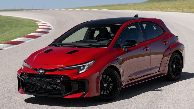 Front 3/4 view of Toyota GR Corolla parked in trackside setting