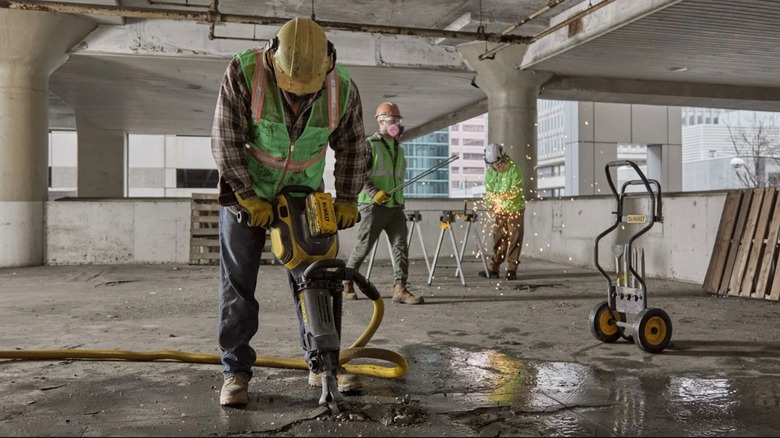 Construction worker using DeWalt demolition hammer