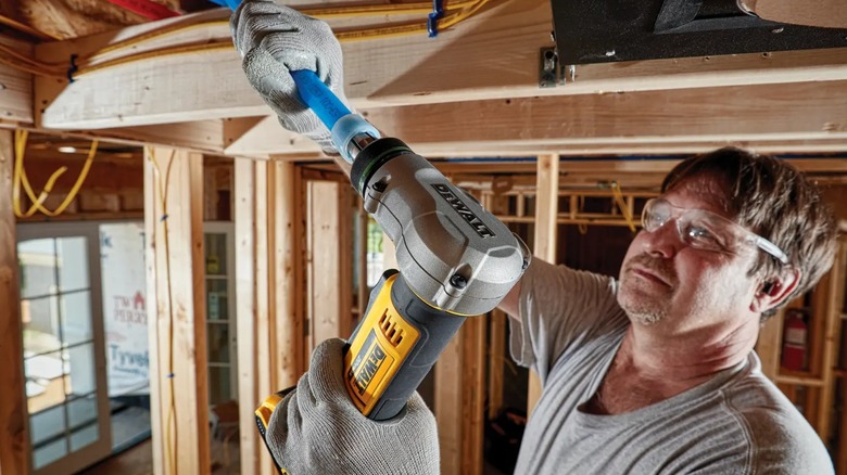 plumber using PEX expander