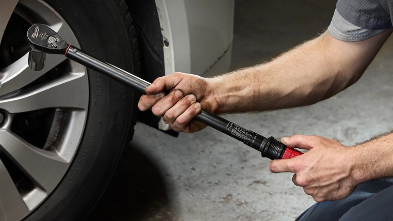 mechanic holding Milwaukee torque wrench
