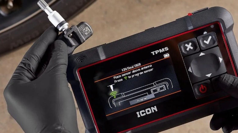 Person holding key to Icon Professional Tire Pressure Monitoring System