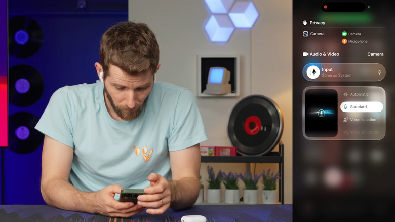 A person using an iPhone, a view of the phone's screen on a side