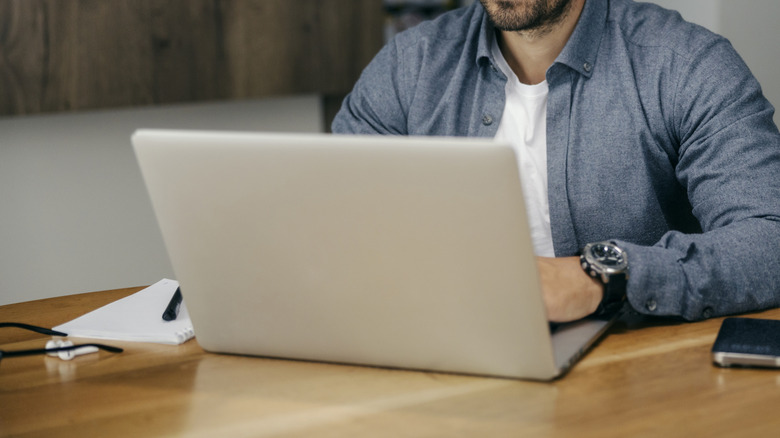 Person working on a laptop at a desk