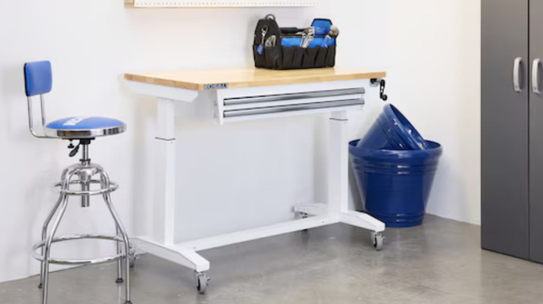 A view of a white Kobalt workbench carrying some equipment