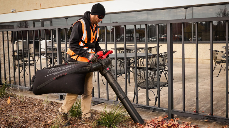 man using mulching vacuum