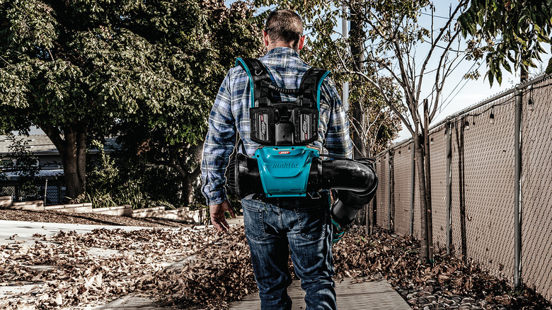 man using Makita blower