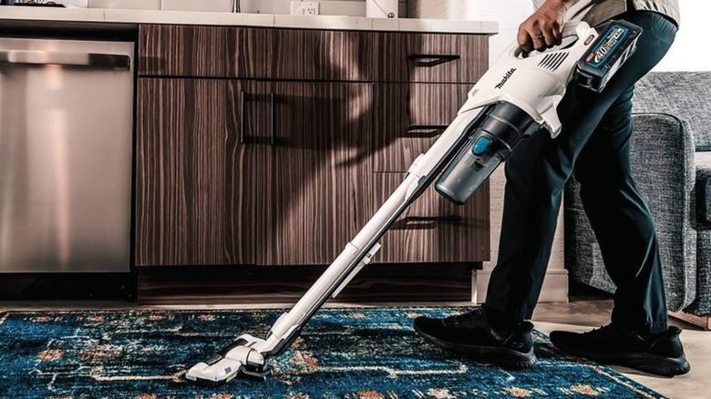 person using Makita vacuum