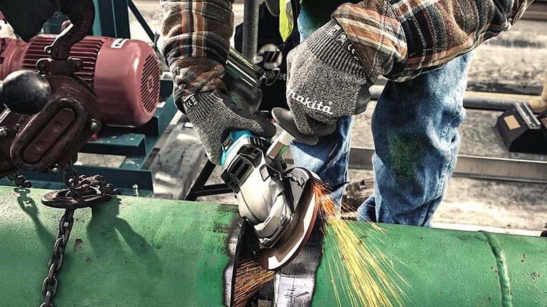 Person using Makita angle grinder