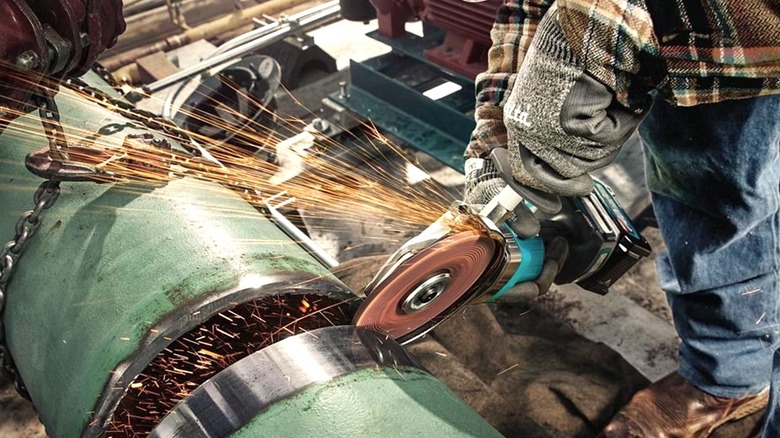 Person using Makita flathead grinder