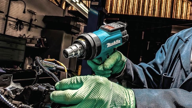 Person using Makita heat gun