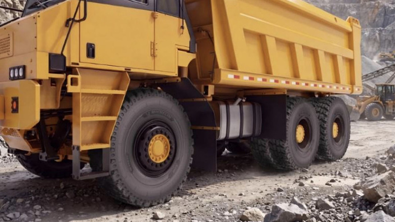 Rendering of Michelin XDR wide body truck tire on dump truck at quarry.