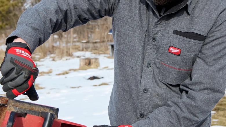 A man wearing a Milwaukee Gridiron flannel shirt.