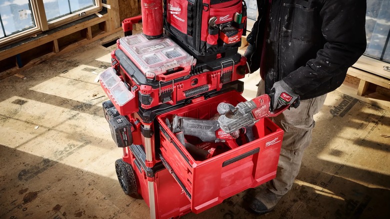 A person retrieving a tool from a Milwaukee Packout Single Drawer Tool Box