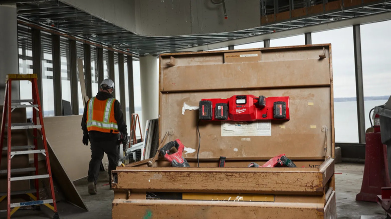 a multiport charger affixed to the lid of a gangbox on a construction site