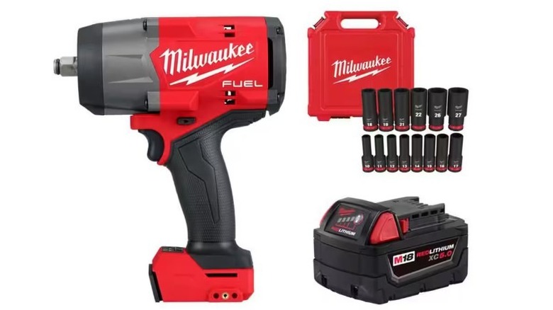 Milwaukee impact wrench, battery, sockets, and case on white background