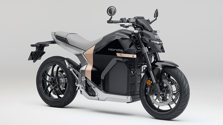 A 2025 Honda WN7, finished in grey and black with a touch of light brown, against a plain gray background.
