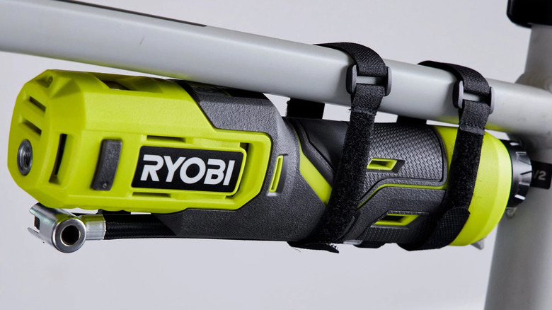 Ryobi USB Lithium bike tire and ball pump inflator strapped to a bicycle frame