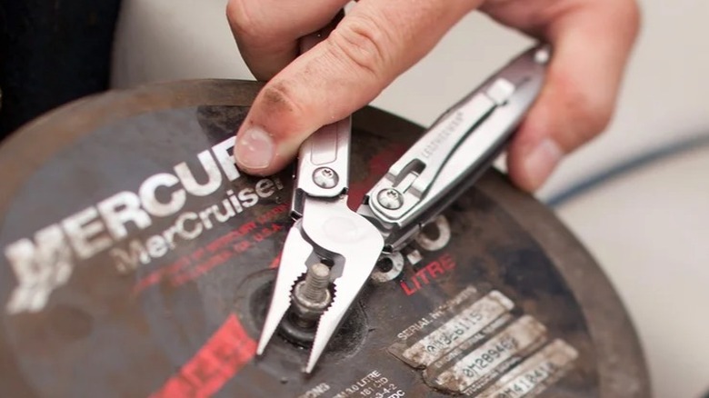 Person using Leatherman Sidekick Multi-Purpose Tool on bolt