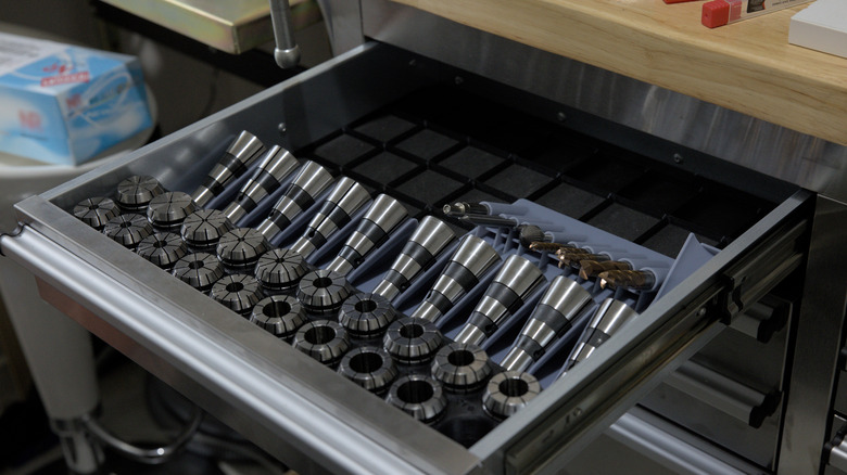 An organized drawer in a tool cart with a wooden top