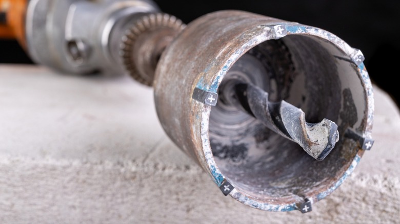 a small coring drill bit attached to a power drill