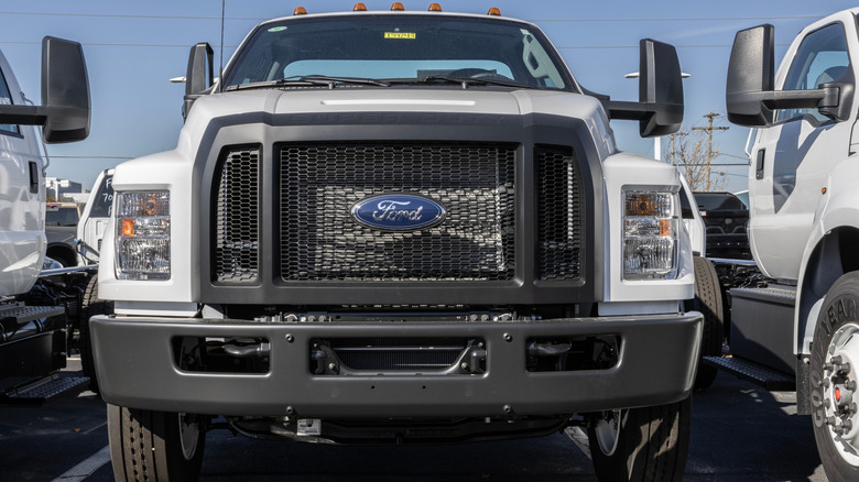 A close-up of a white Ford F-650's front end