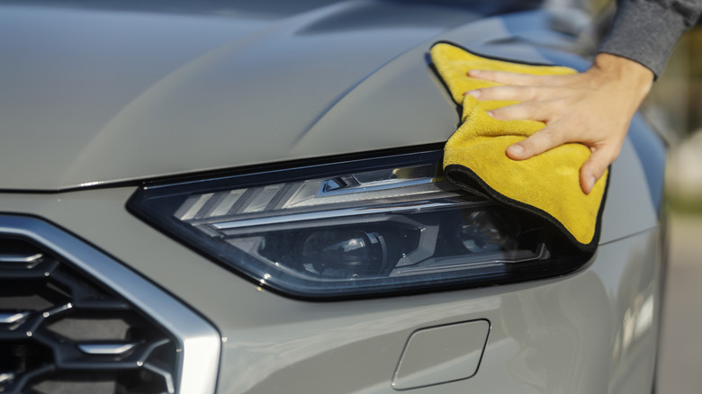 A close-up of an Audi LED headlight cleaning.